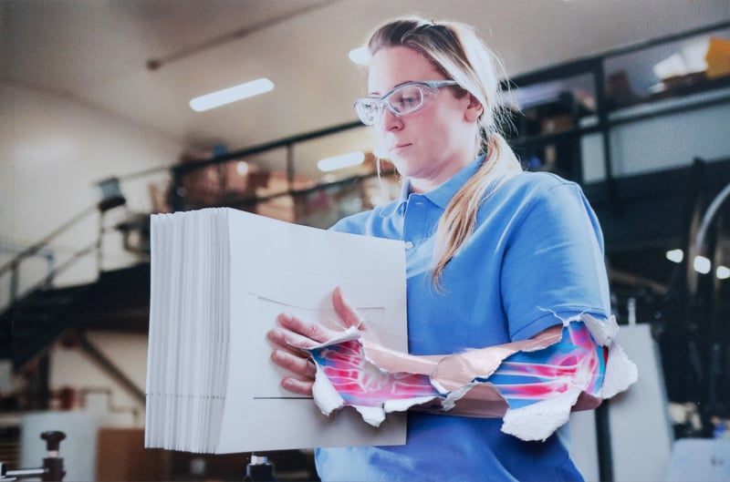 woman packing boxes overlay of an xray on her arm reveals repetitive stress injury